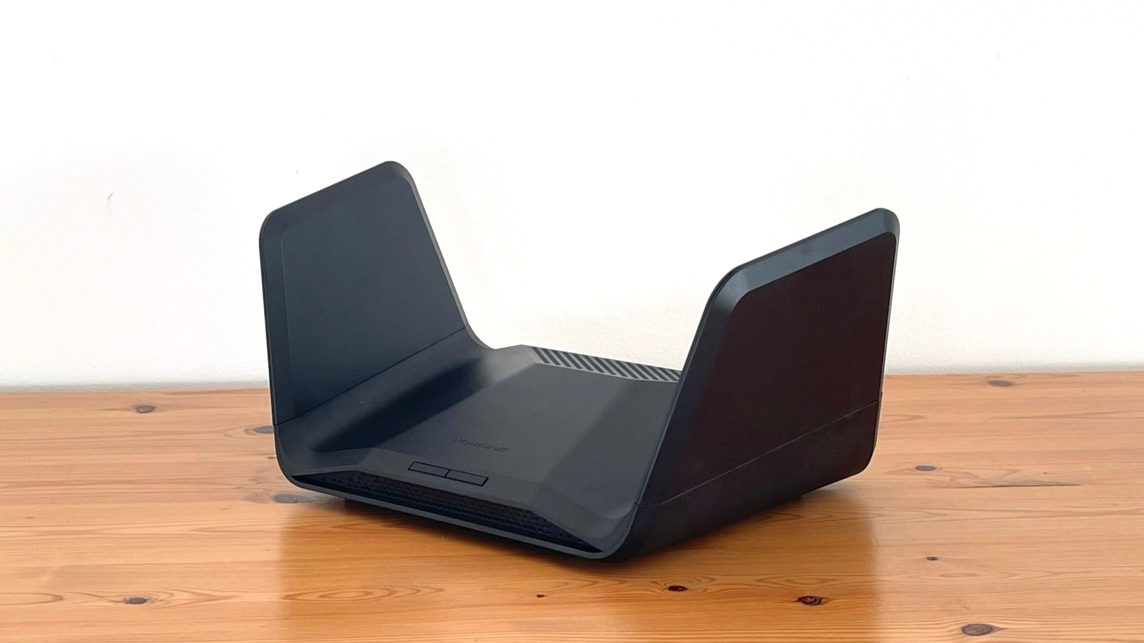 Netgear Nighthawk RAXE300 on top of a wooden desk