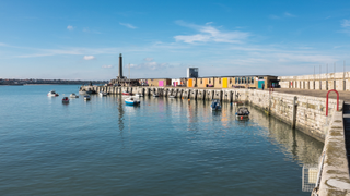 A picture of the colourful doors and red brick buildings along Margate's harbour arm