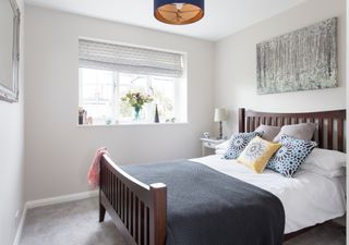 A bedroom with white walls and a double bed