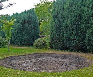 digging a hole in a lawn to install an in-ground trampoline