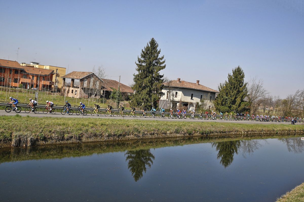 The peloton passes by a stream mid-stage.