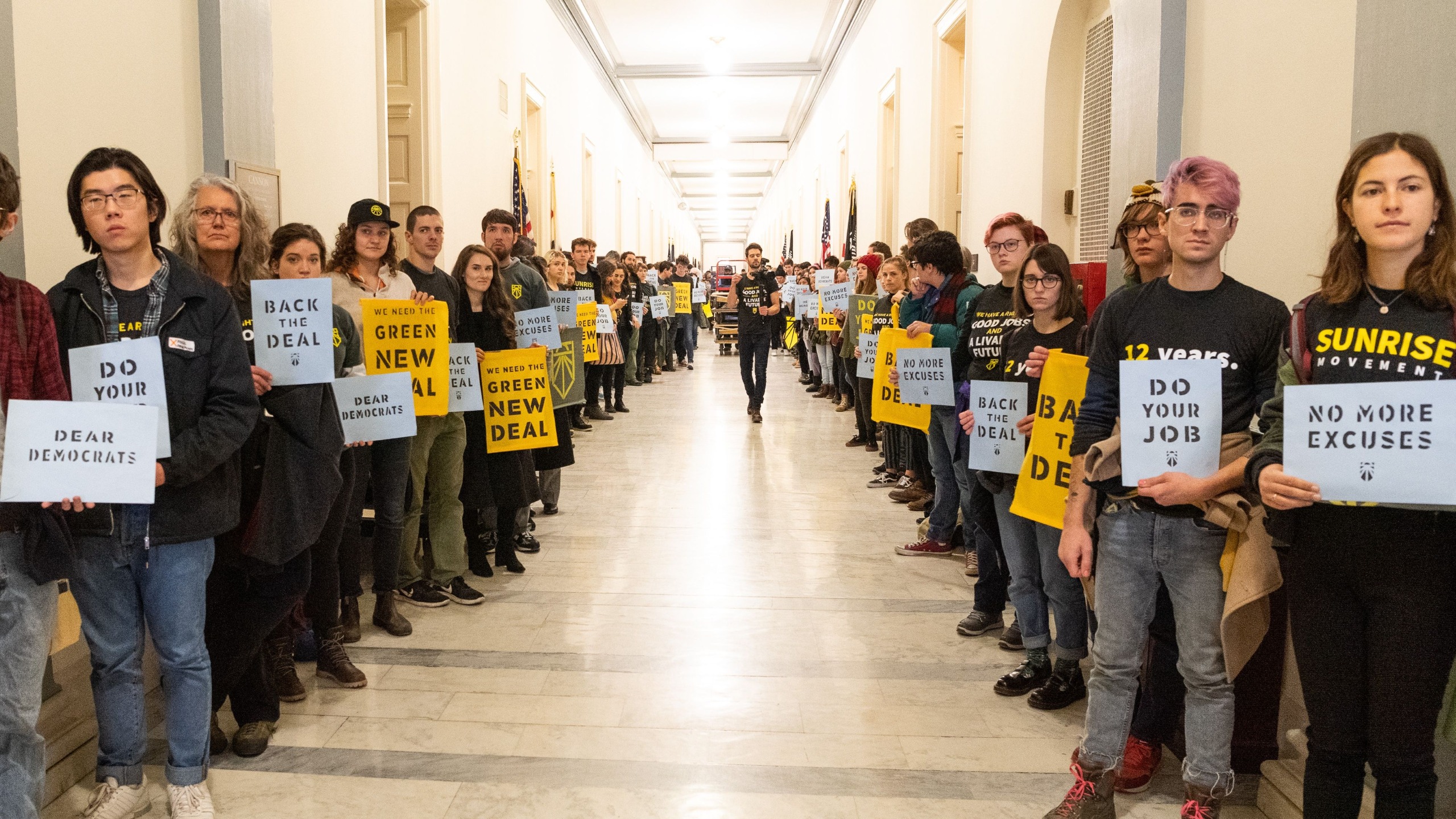 protestors lining a hall with placards in the US Capitol building