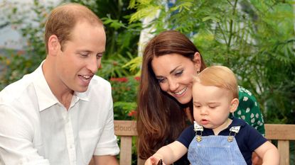 ) Catherine, Duchess of Cambridge holds Prince George as he points to a butterfly on Prince William, Duke of Cambridge's hand as they visit the Sensational Butterflies exhibition at the Natural History Museum on July 2, 2014 in London, England. The family released the photo ahead of the first birthday of Prince George on July 22.