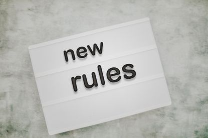 white and black sign saying new rules
