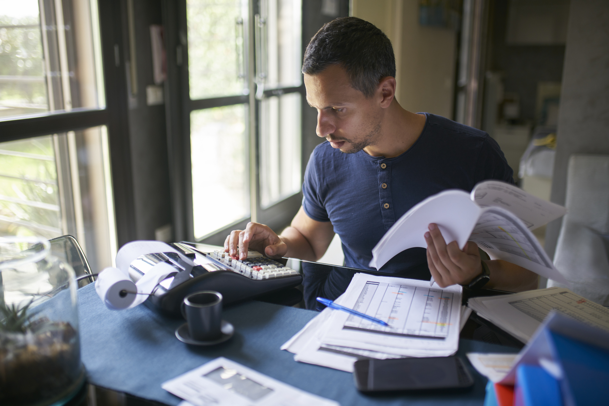 Man preparing his taxes at home