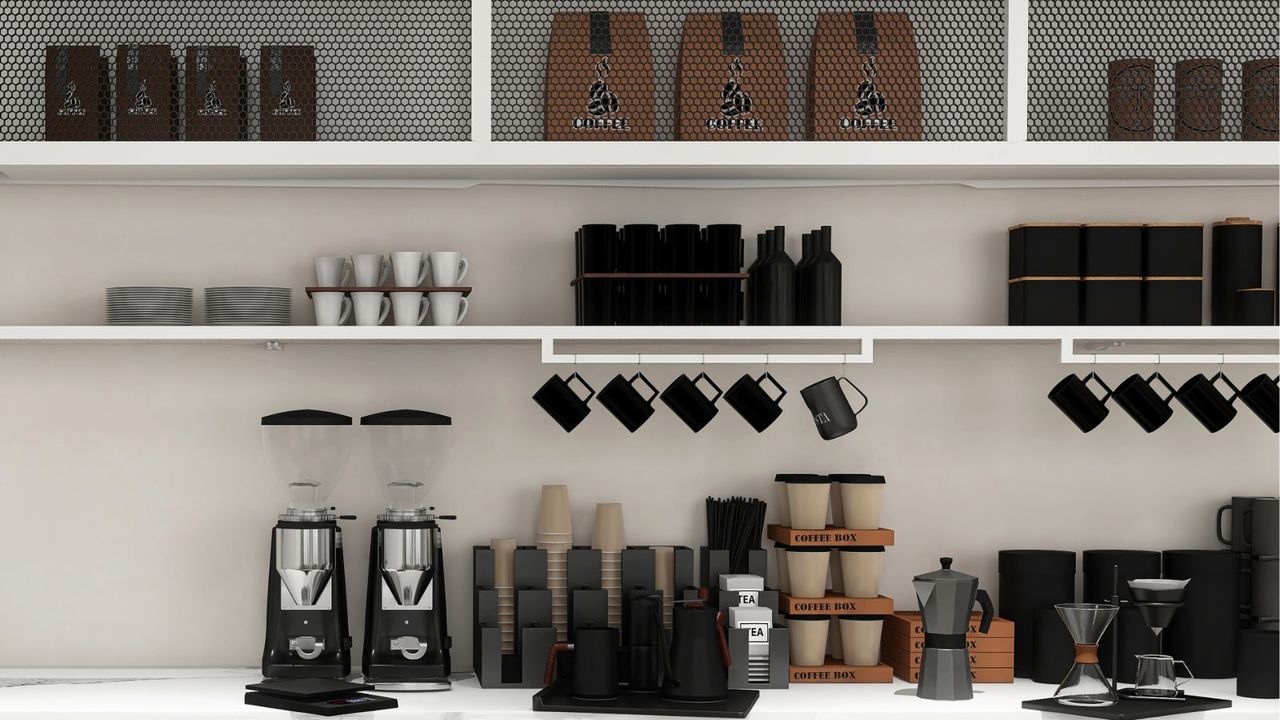 blade vs burr coffee grinder: two coffee grinders on a cafe countertop with coffee cups and mugs