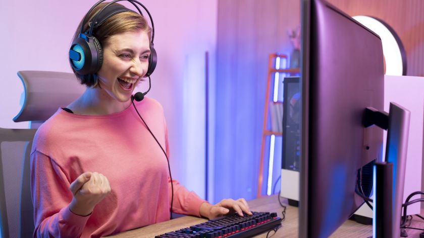 Young woman live streaming while playing multiplayer online game in living room at home - stock photo