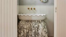 a powder room with a sink skirt