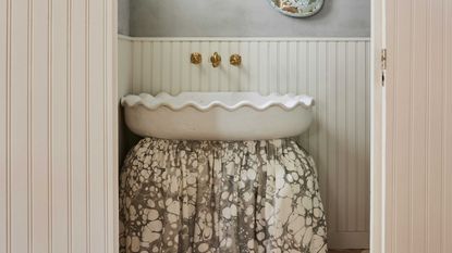 a powder room with a sink skirt