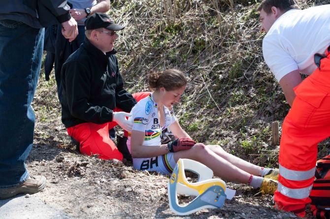Julie Bresset is tended by medics after crashing and breaking her collarbone in Germany