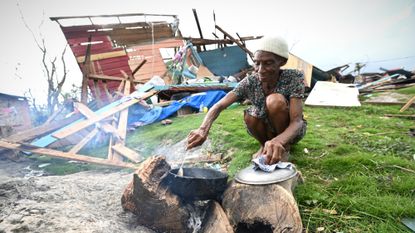 Jamaican woman cooks outdoor in wreckage from Hurricane Melissa