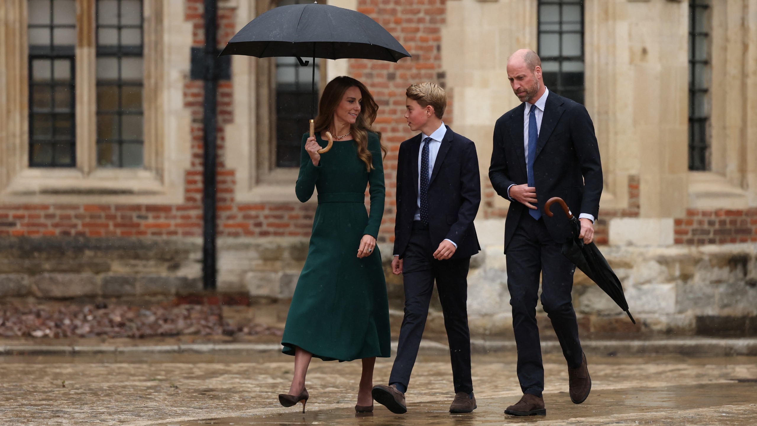 Catherine, Princess of Wales (L) and Prince William (R) walk with Prince George (C), as he arrives for his first day at Eton College, in Eton, west of London, on September 8, 2026