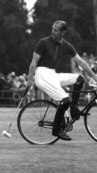 Prince Philip riding a bicycle playing polo