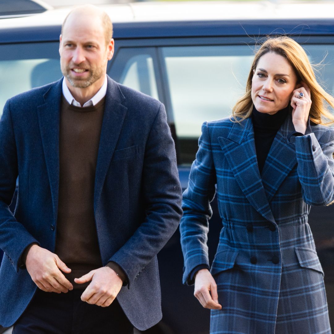 Prince William walking next to Princess Kate, who is wearing a blue tartan coat