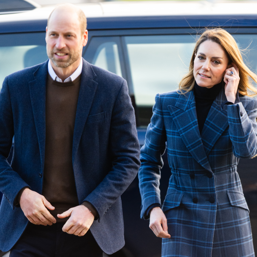 Prince William walking next to Princess Kate, who is wearing a blue tartan coat