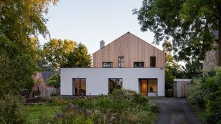 a self build home with house rendering on the lower portion