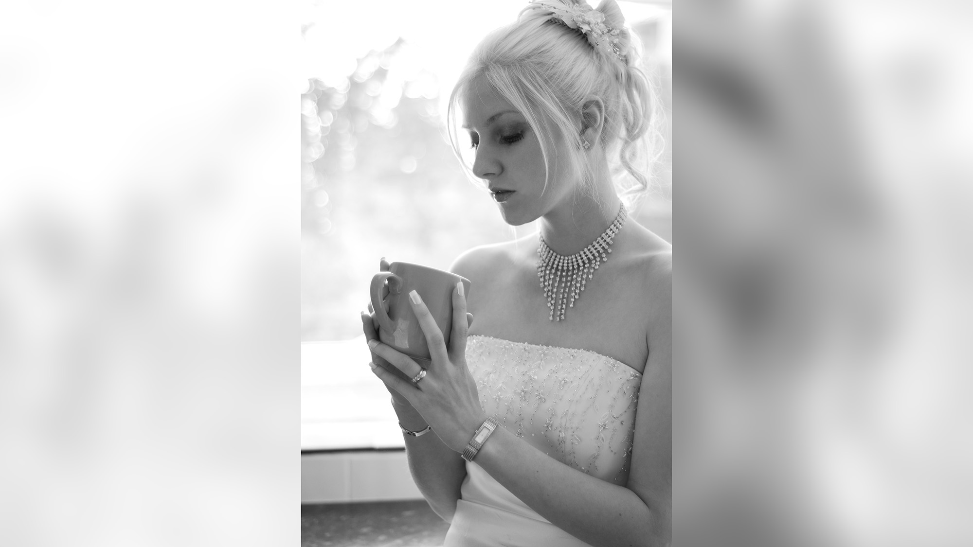 Bride, backlit by window, looking thoughtful