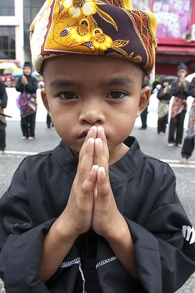 Hopefully this young local was praying for no more rain on the 2011 Tour de Langkawi!