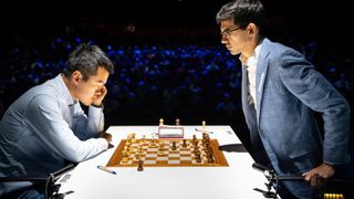 Dutch chess grandmaster Anish Giri (R) and world champion Ding Liren (L) ahead of the World Chess Championships 2024