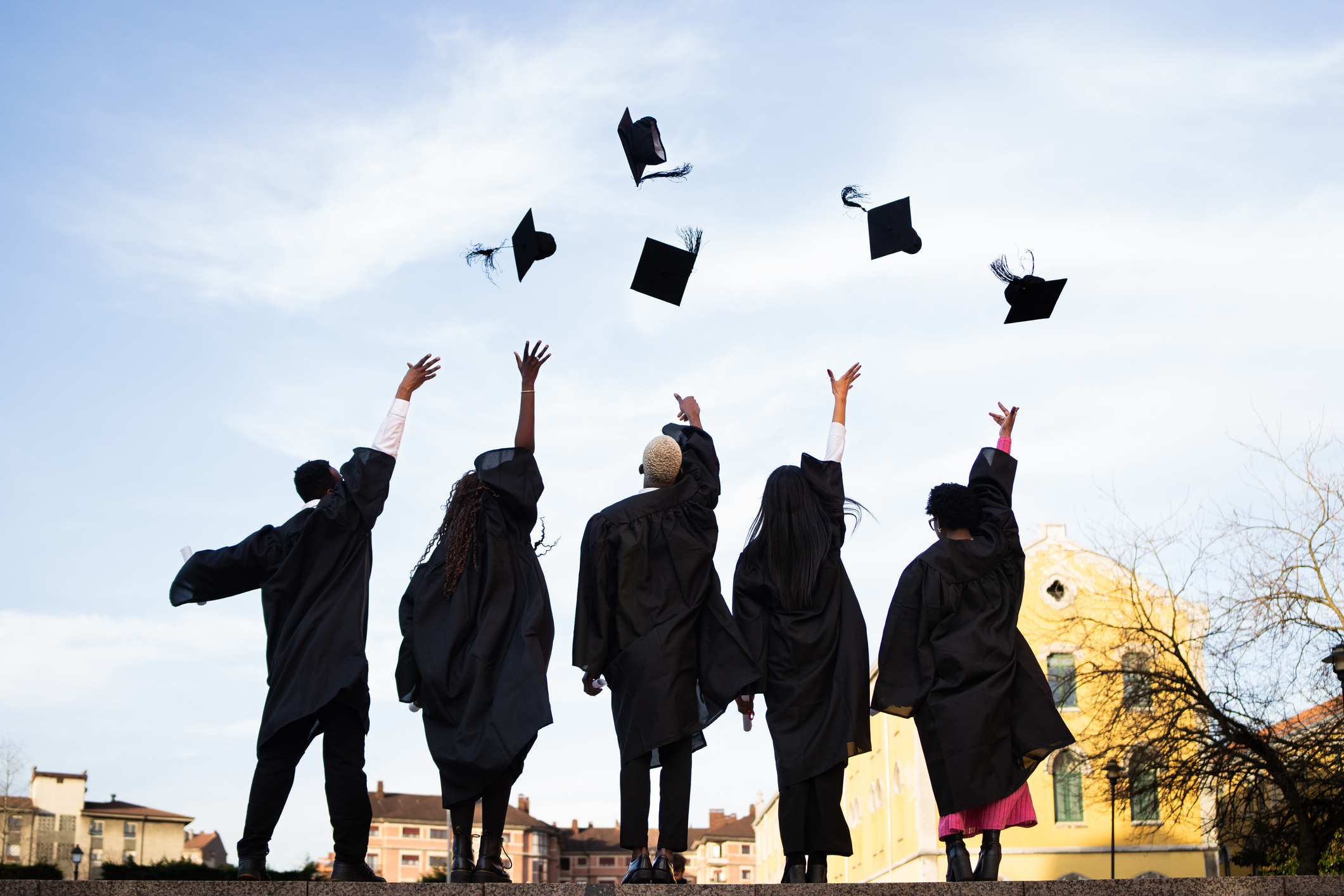 Graduates throwing their caps in the air