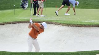 A golfer hits from a bunker at the 18th hole of the 2025 PGA Championship