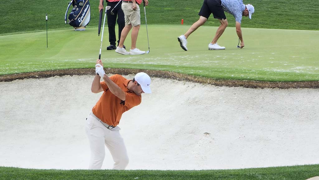 A golfer hits from a bunker at the 18th hole of the 2025 PGA Championship