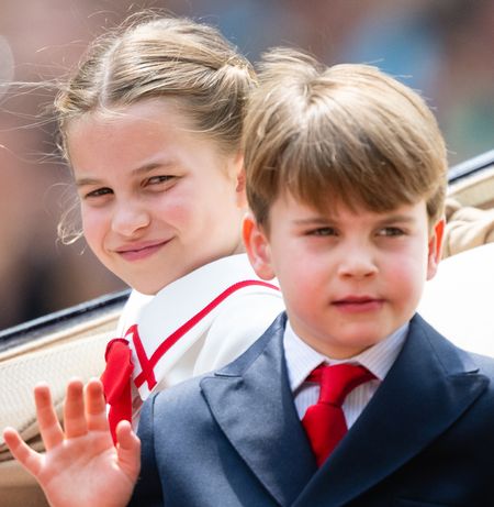 Princess Charlotte and Prince Louis waving in a carriage at Trooping the Colour 2023