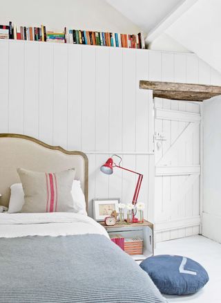 bedroom with book shelve and door