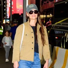 Katie Holmes walks into the theatre for her Broadway show wearing a fall shacket, jeans, and wine red ballet flats