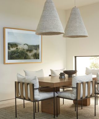modern organic dining room with large oversized rattan light fixtures