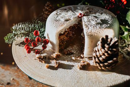 Close up of a Christmas cake decorated with icing and decorated