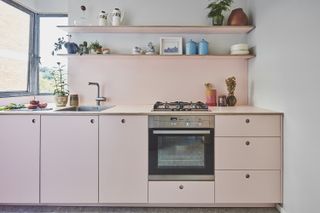 Pink mid-century kitchen inside a n apartment