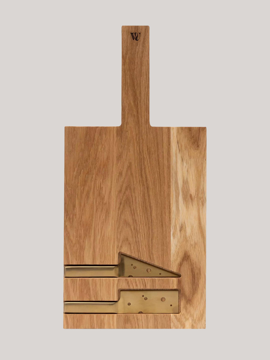 A wooden cheese board with a cheese-themed gold knife set