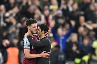 Arsenal's Spanish manager Mikel Arteta (R) congratulates West Ham United's English midfielder Declan Rice (L) at the end of the English Premier League football match between West Ham United and Arsenal at the London Stadium, in London on May 1, 2022.