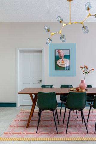 Dining room with color block effect around picture