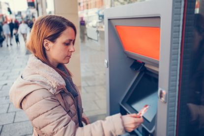 Woman withdrawing money from a cash machine