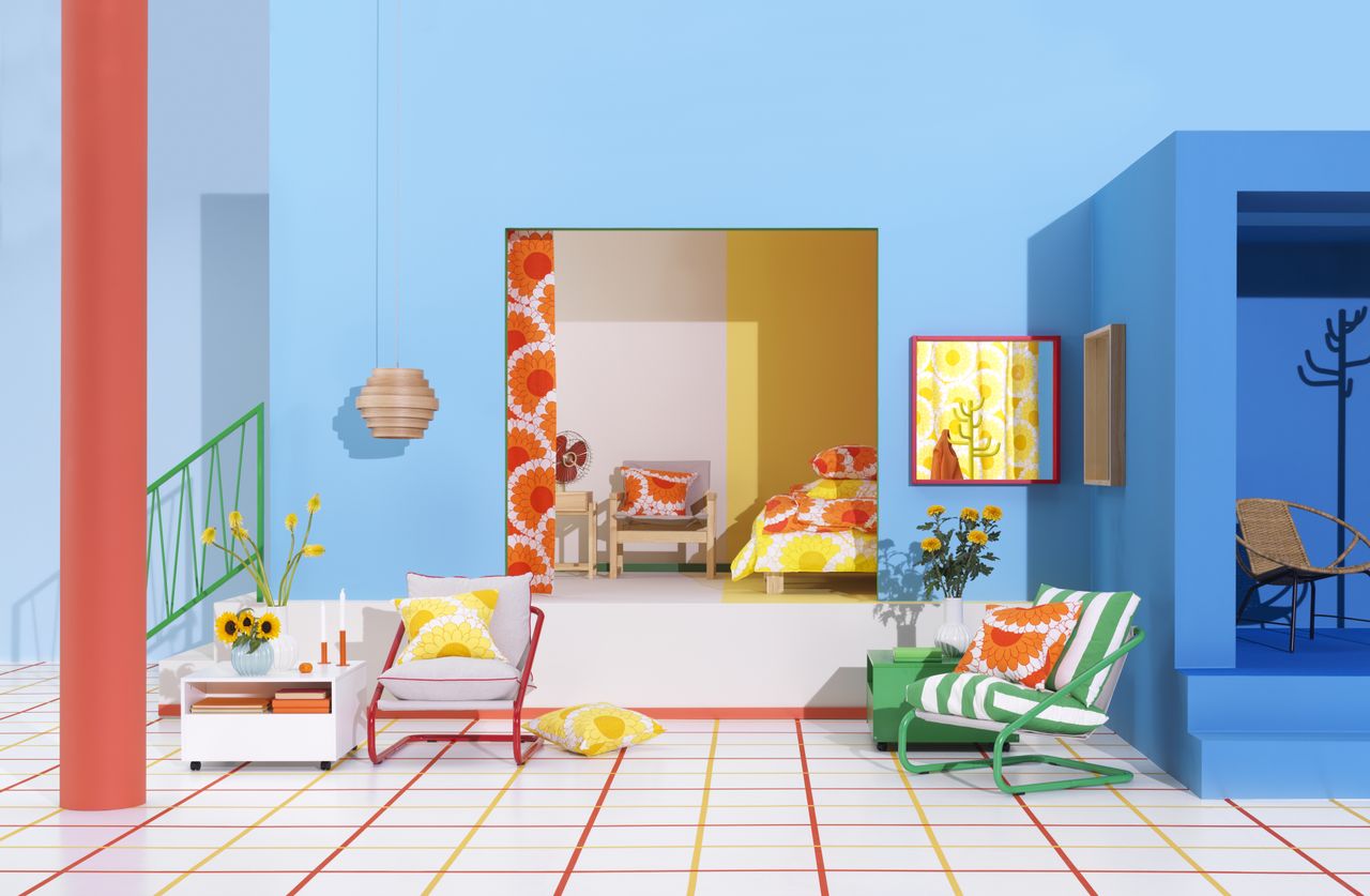 Red and green metal armchairs, wood-framed mirrors and sunflower print set against the inside of a blue home