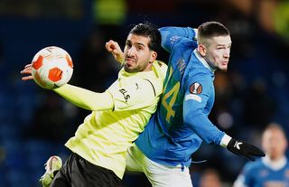 Borussia Dortmund’s Emre Can (left) and Rangers’ Ryan Kent battle for the ball