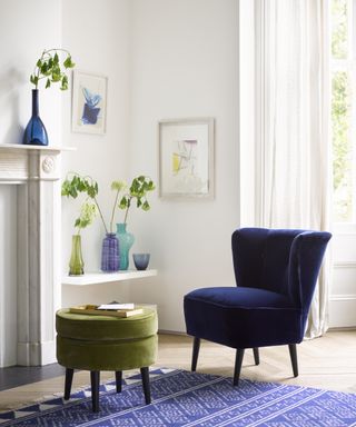 Green and blue color pops in bright and breezy scheme, with fresh stems in colored glass vessels.