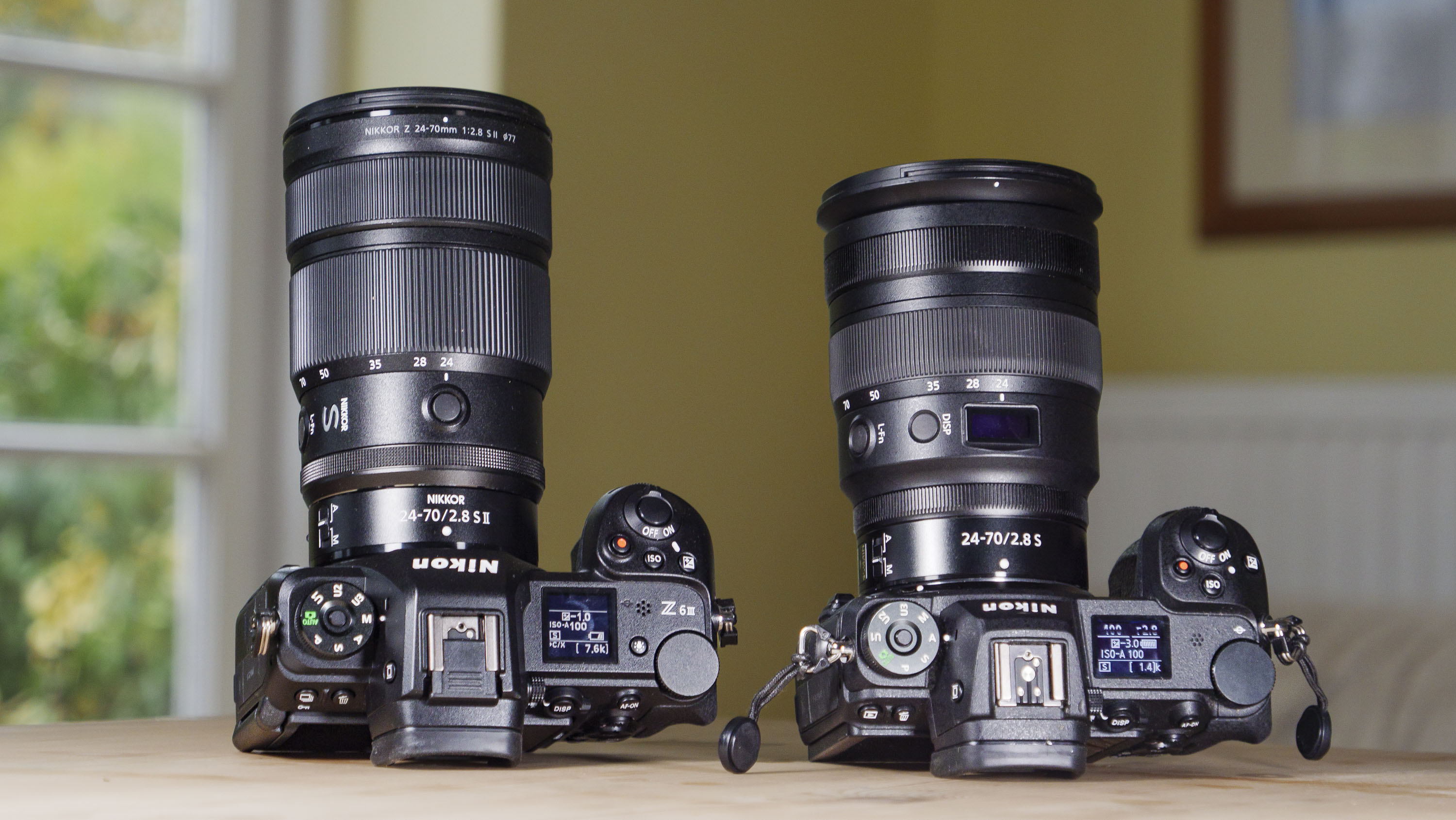 Nikon Z 24-70mm f/2.8 S II lens mounted to a Nikon Z6 III, alongside Nikon Z 24-70mm f/2.8 S lens attached to a Nikon Z6 II
