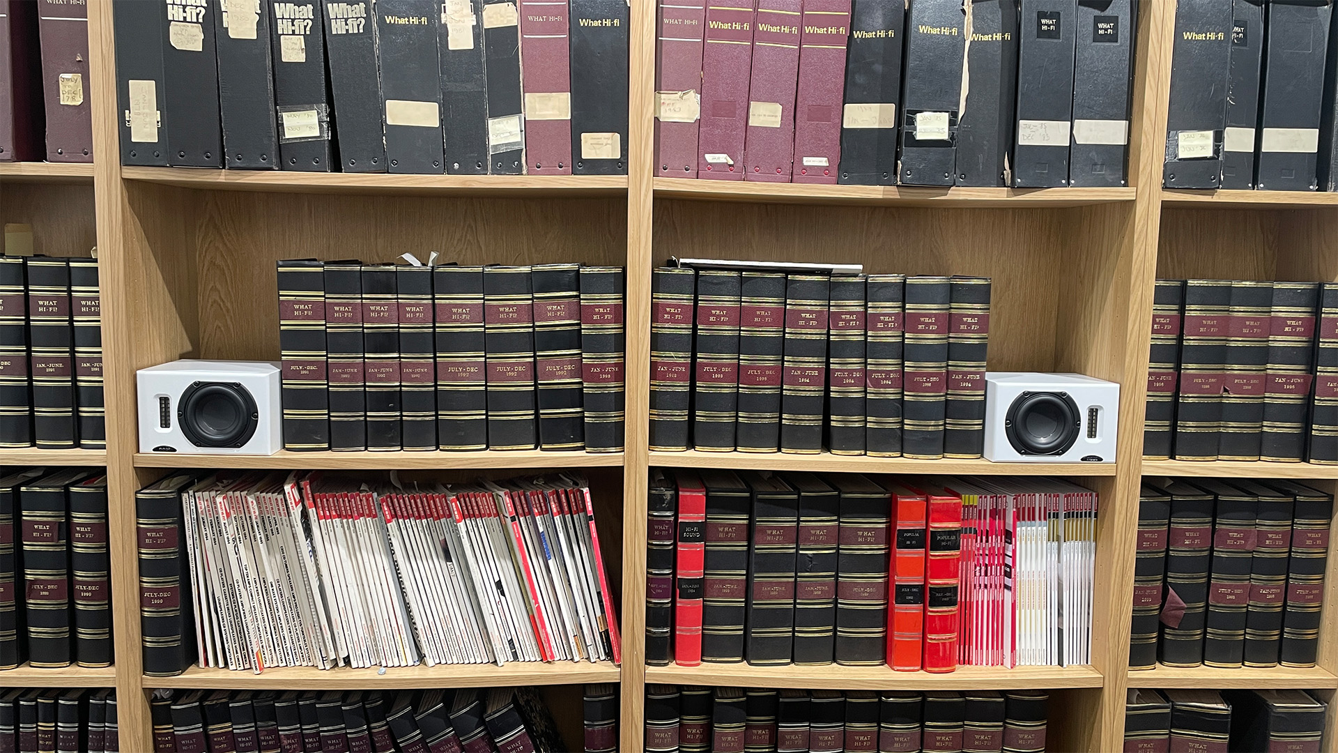 Neat Iota II speakers placed inside a bookshelf