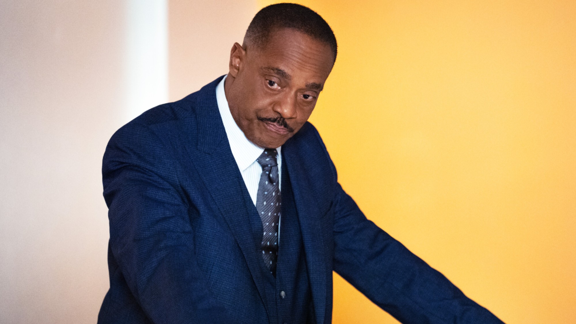 Vance leaning against a railing on NCIS.