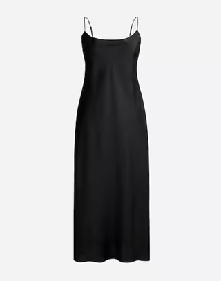 a black slip dress from jcrew in front of a plain backdrop