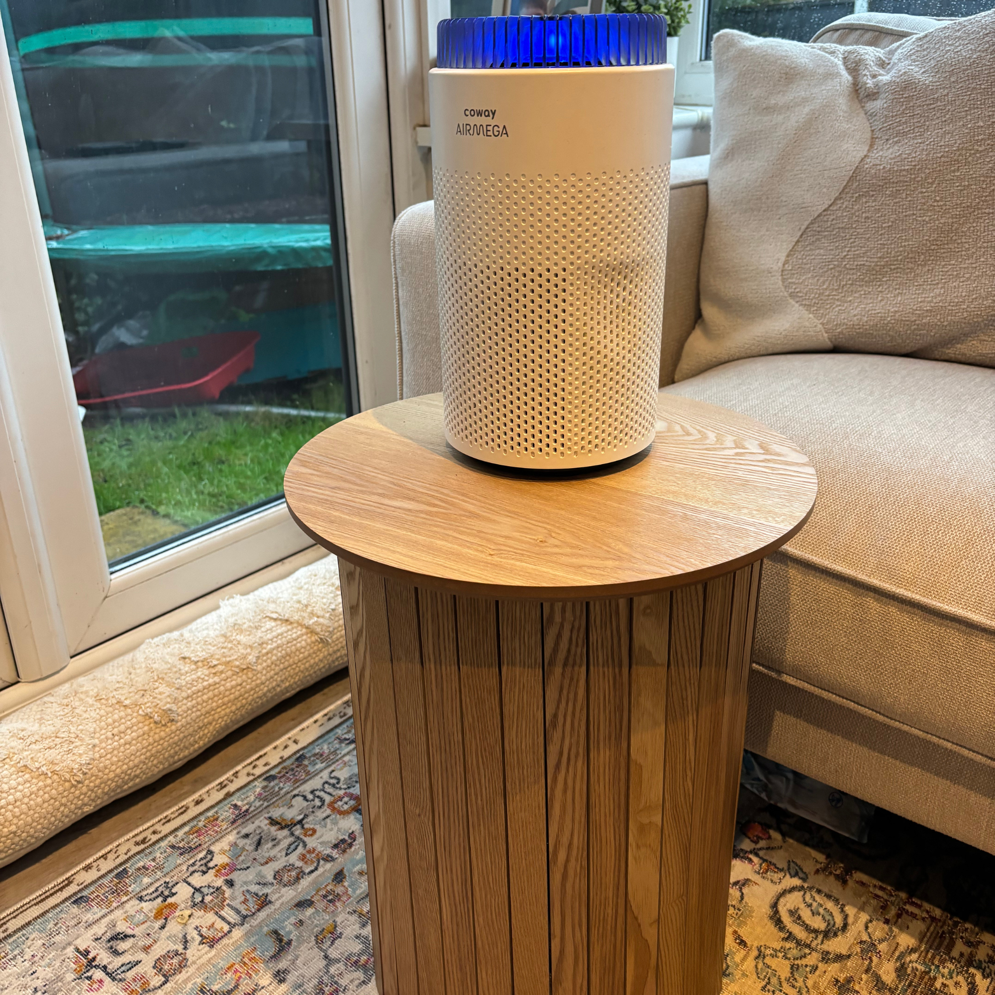 Coway Airmega 50 sat atop side table