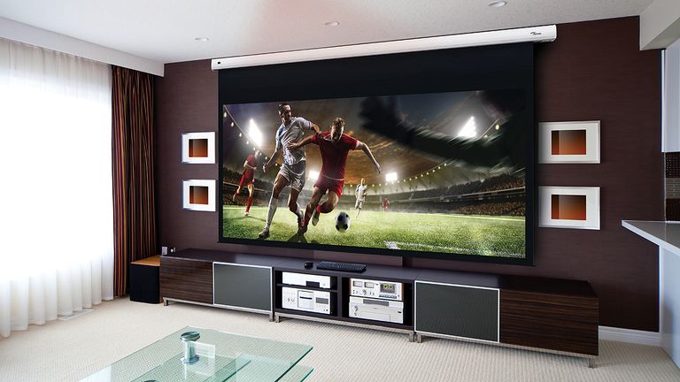 Best projector 2022, image shows projector image of a football match on a screen in a living room