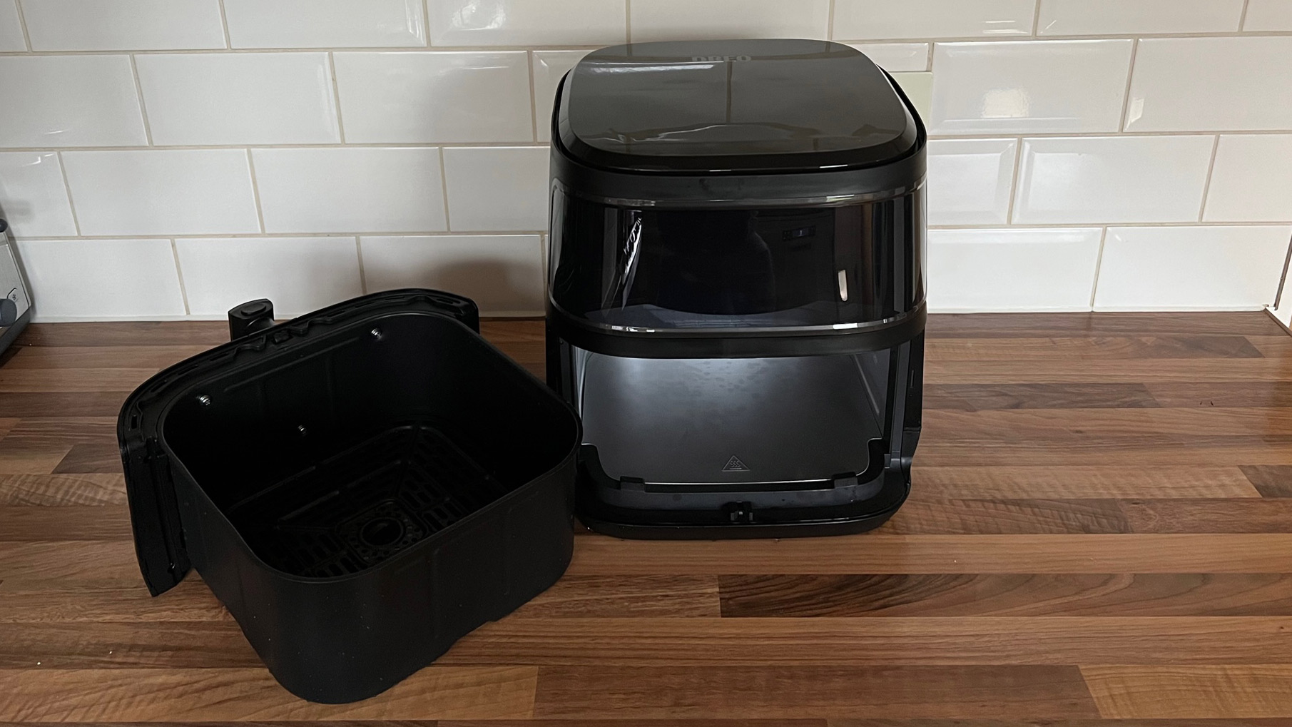 The Dreo 6-Quart Air Fryer with the frying basket removed