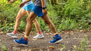 Two people walking on trail wearing Keen WK400 shoes