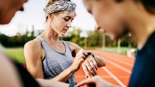 Woman checking her smartwatch after a run