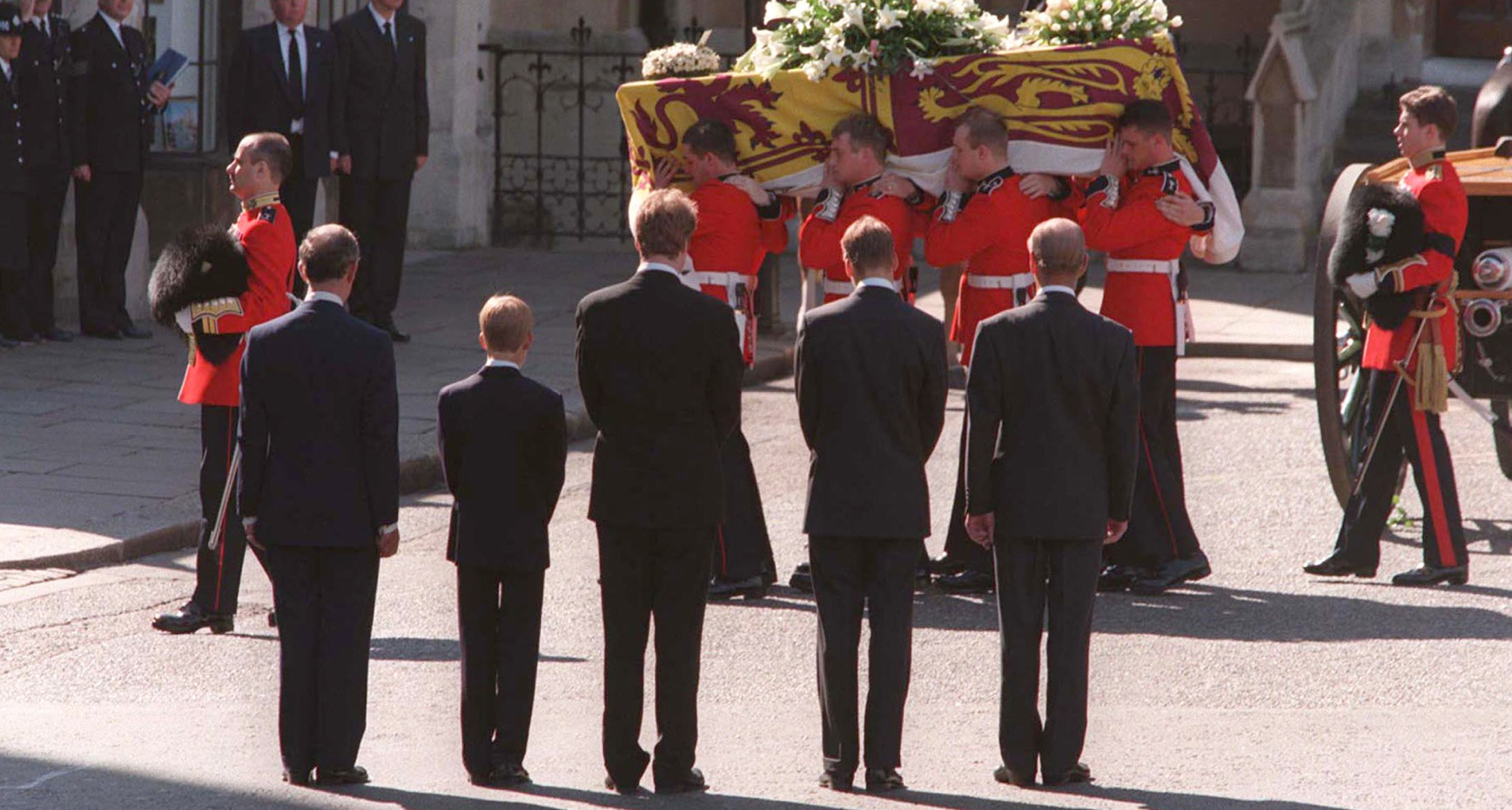 Earl Spencer, Prince Harry, Prince Philip, Prince WIlliam and Prince Charles standing in front of Princess Diana's coffin with their backs to the camera