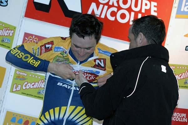 Borut Bozic (Vacansoleil Pro Cycling Team) puts on the leader's jersey